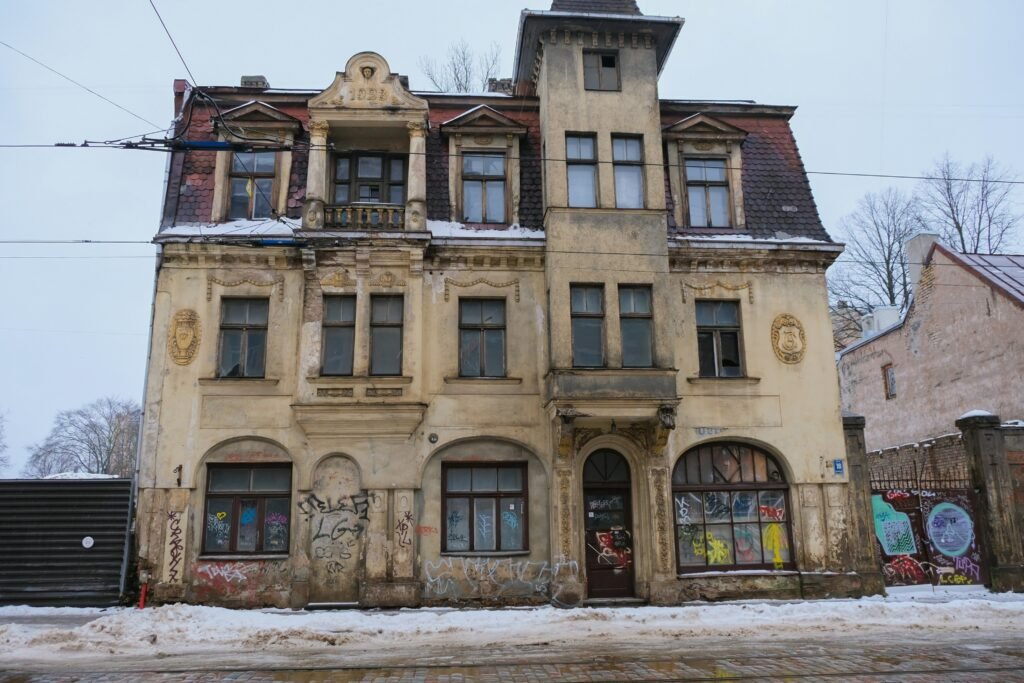 an old building with graffiti on the side of it